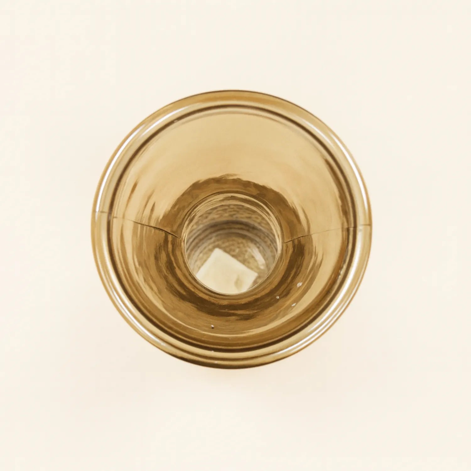 Amber glass vase on a beige background