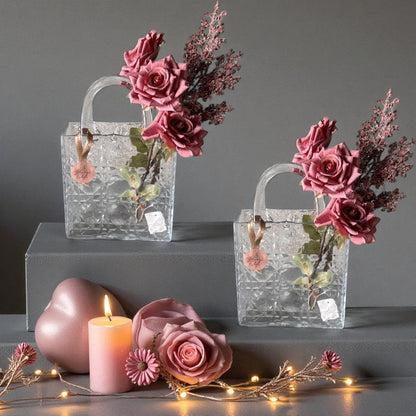 Decorative glass bags with floral arrangements on a gray background