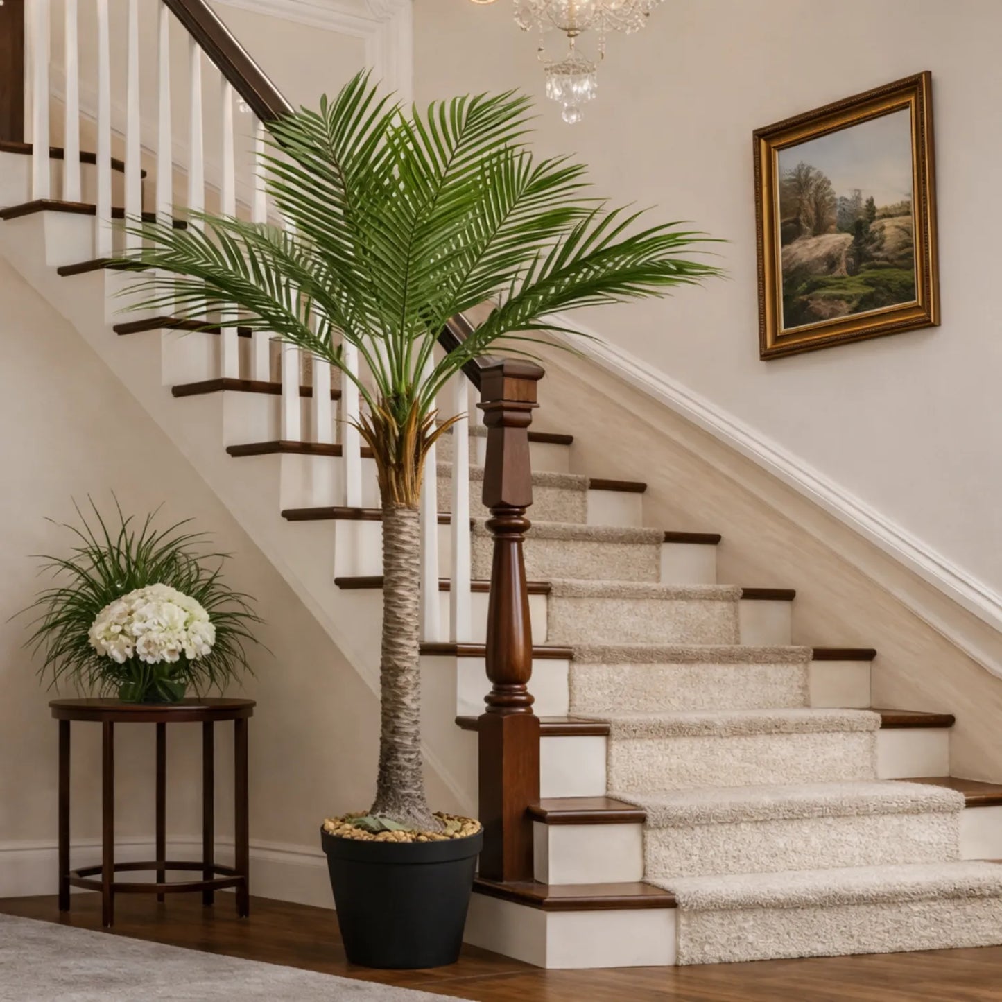 Staircase with a large potted plant and a small table with flowers in a home setting.