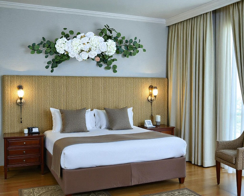 Neatly made bed in a bedroom with decorative elements and furniture.