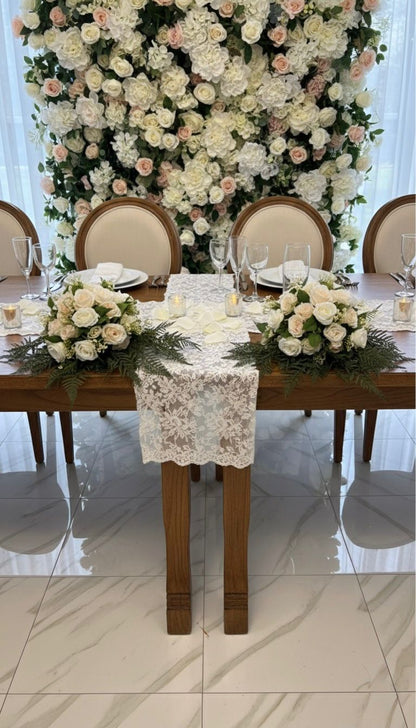 Decorated table with floral arrangements and chairs in a formal setting.