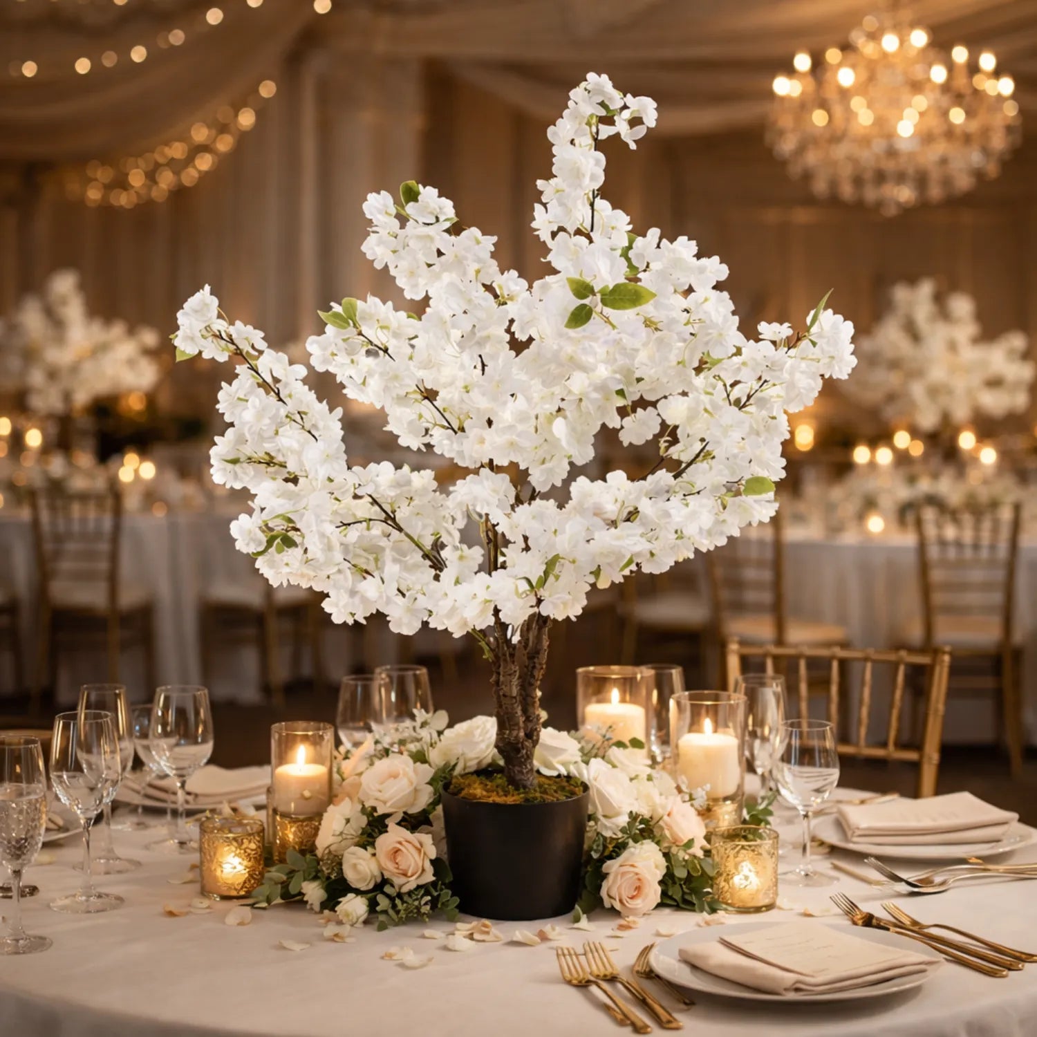 Decorative table setting with white floral centerpiece in a banquet hall.