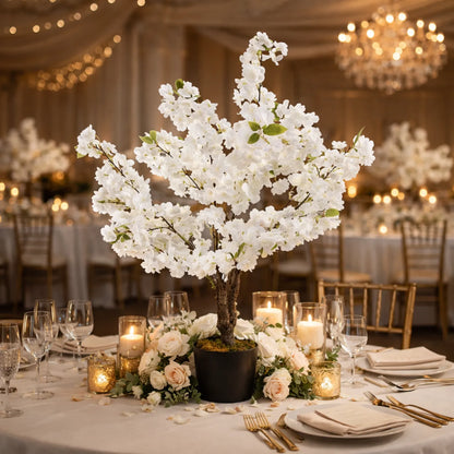 Decorative table setting with white floral centerpiece in a banquet hall.