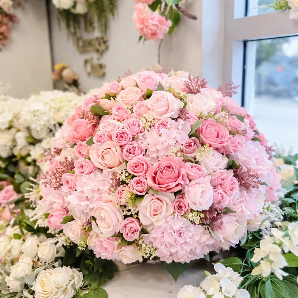 Bouquet of pink and white flowers with a blurred floral background