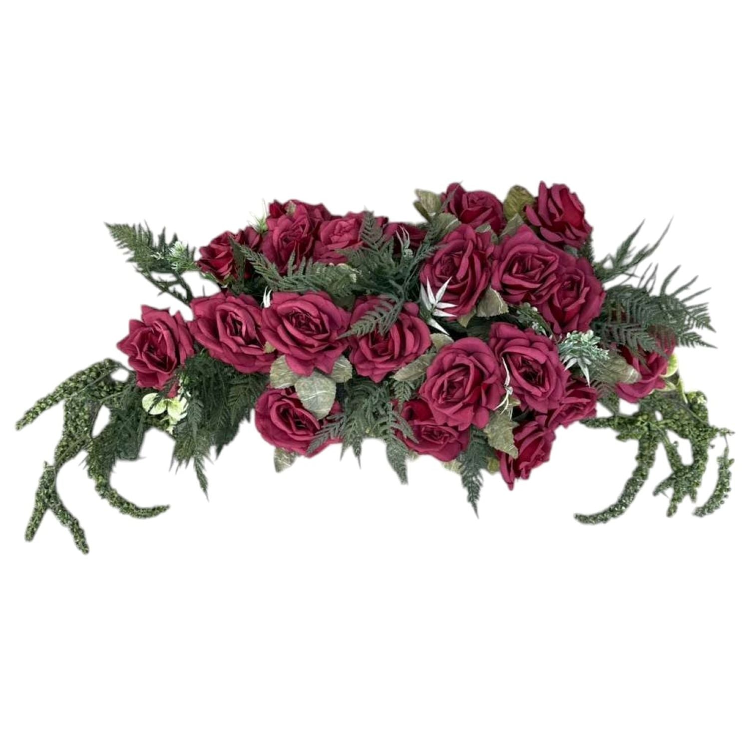 Artificial flower arrangement with red roses and greenery on a white background
