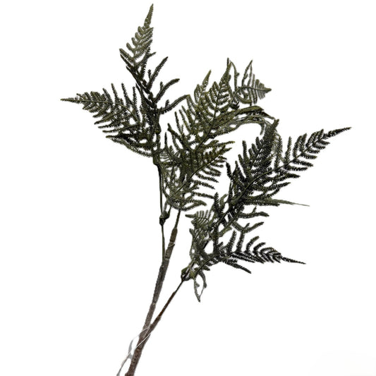 Artificial fern branch on a white background