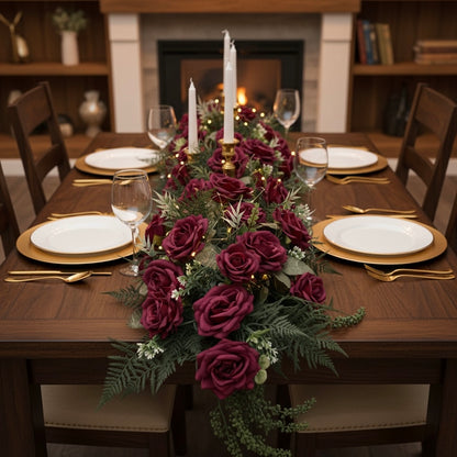 Dining table set with a floral centerpiece, candles, and gold cutlery in a cozy room.