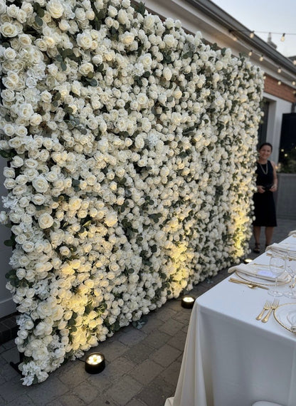Floral wall with white flowers and table setting in front