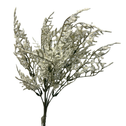 Decorative branch with glittery leaves on a white background