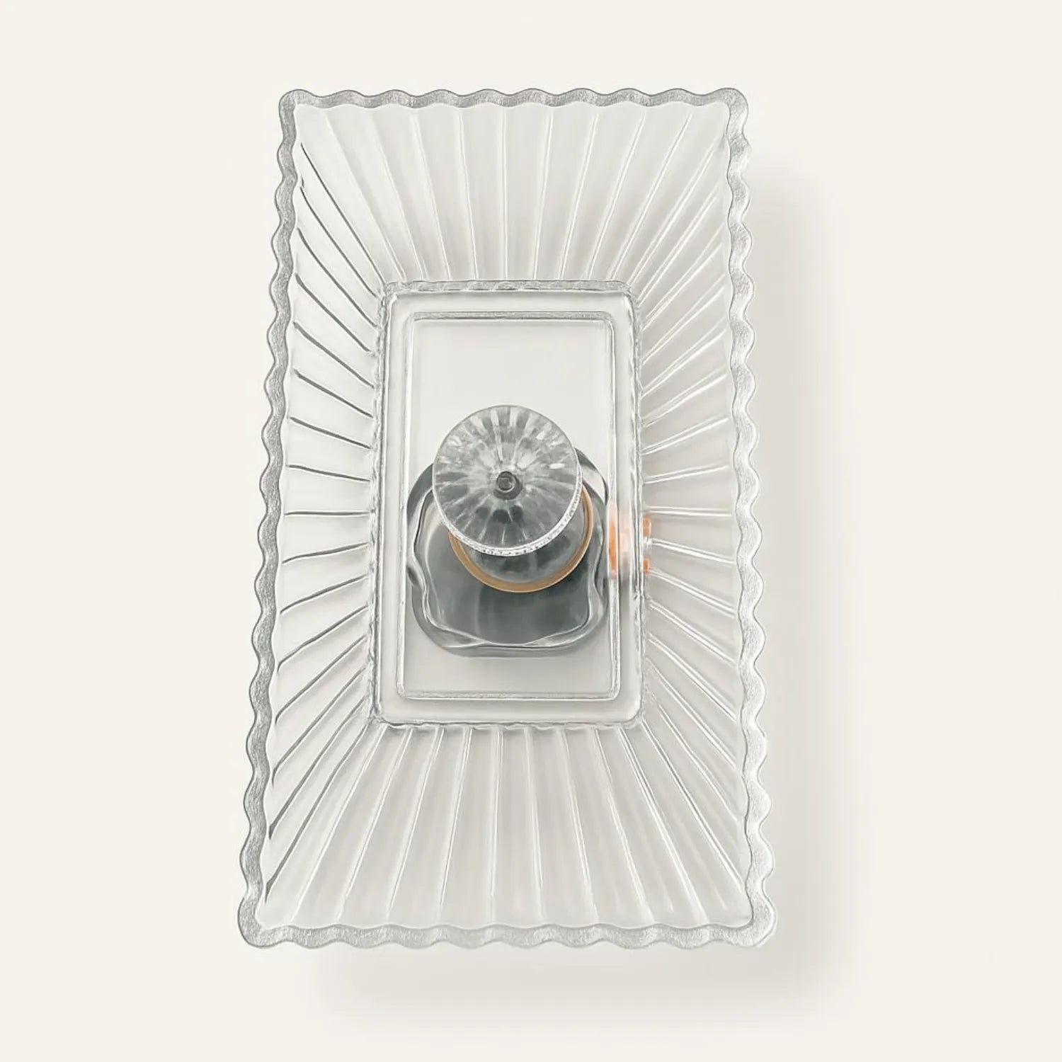 Decorative wall light fixture with a clear glass shade on a white background