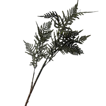 Artificial fern branch on a white background