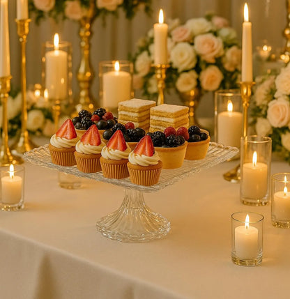 Decorative table setting with cupcakes, candles, and flowers