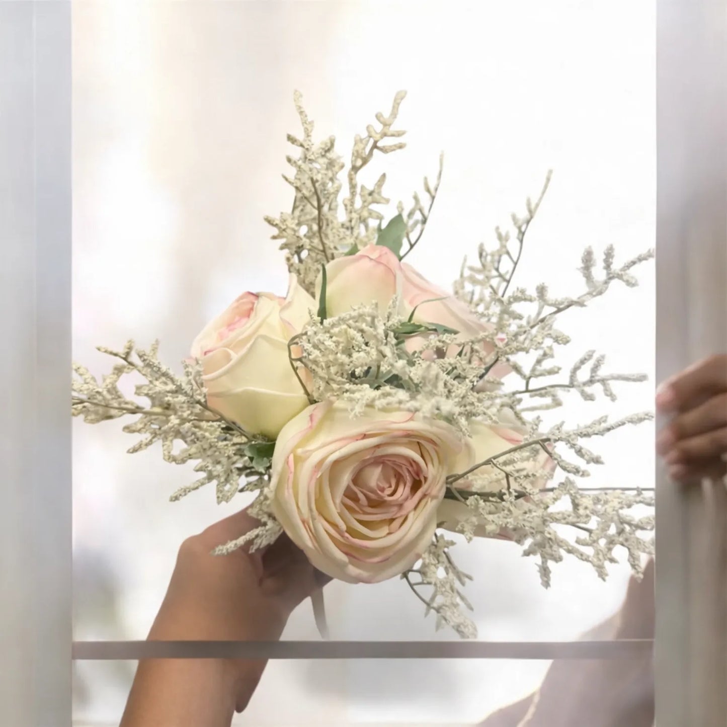 Bouquet of flowers held by a person with a blurred background