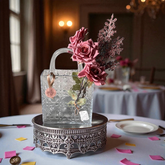Decorative glass handbag with flowers on a table setting in a formal dining room.