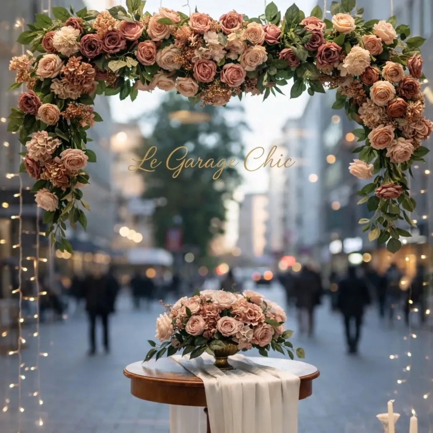 Decorative floral arch with 'Le Garage Chic' branding in an urban setting.