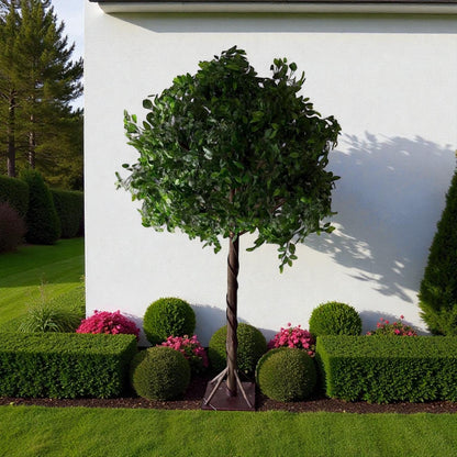 Artificial topiary tree with green leaves and pink flowers in a garden setting.
