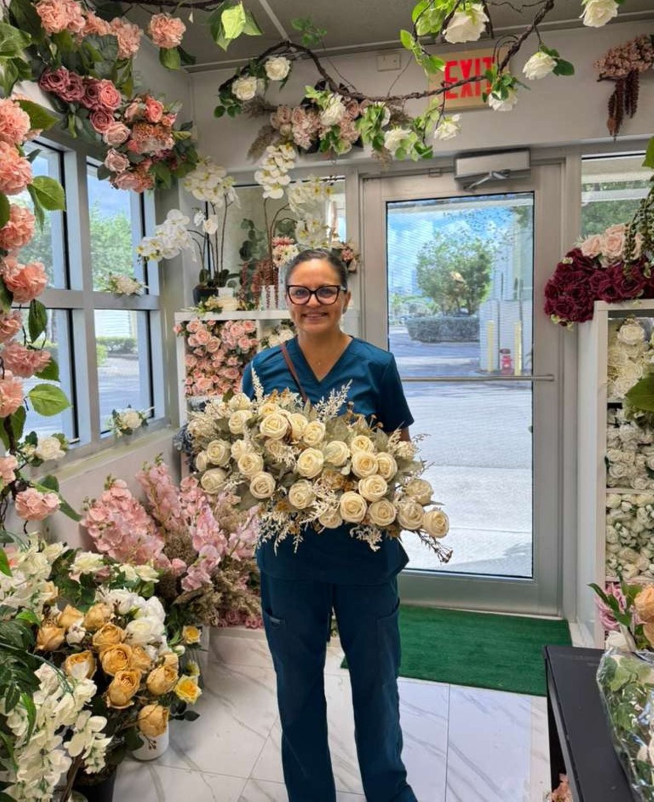 Person holding a bouquet of flowers in a flower shop