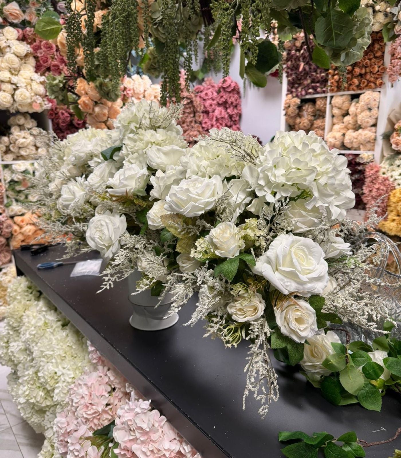 Floral arrangement on a table with a colorful background of flowers